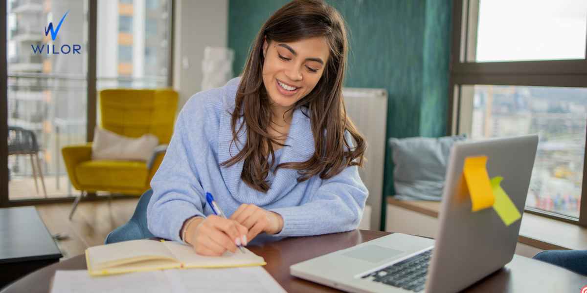 Student studying online at home with laptop and notepad, learning about the UK Lifelong Learning Entitlement scheme.